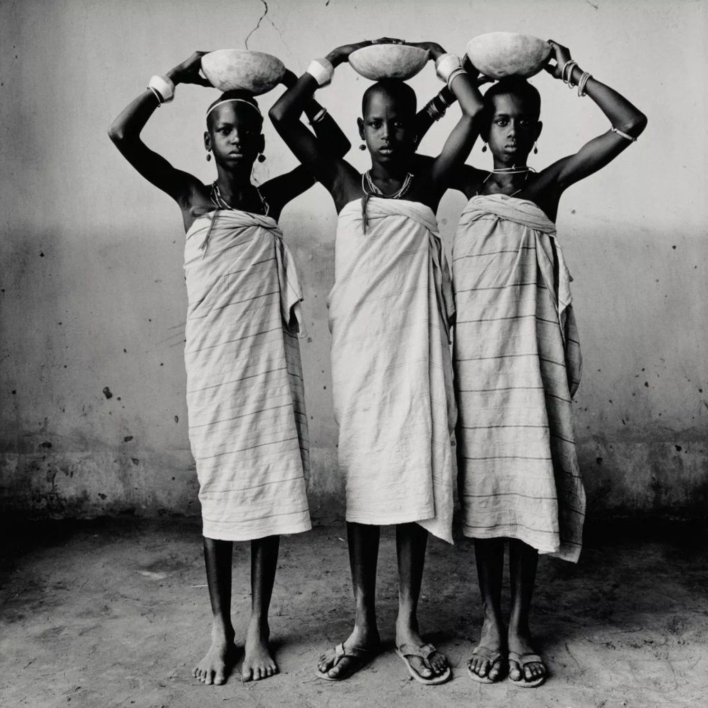 Irving Penn. Three Dahomey Girls (with Bowls), Dahomey, 1967.  Gelatin silver print mounted to board. 13-7/16" × 13-7/16" (34.1 cm × 34.1 cm), image and paper 17" × 17" (43.2 cm × 43.2 cm), mount